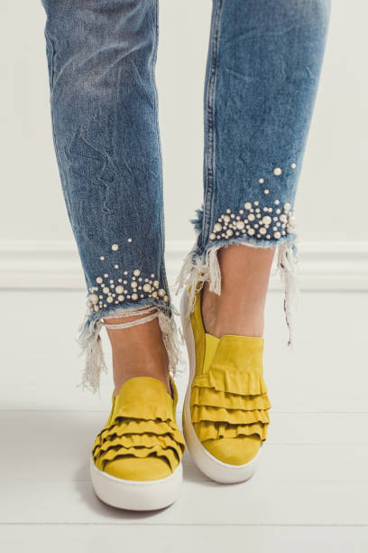spring summer fashion jeans and yellow shoes foot and legs spring summer fashion denim and yellow shoes foot and legs yellow shoes stock pictures, royalty-free photos & images