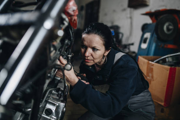 istock Man worker in motorcycle repair shop 929147416