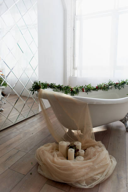 istock Bath on lion's paws, decorated with flowers. On the floor are candles.A romantic setting for a date 929151496