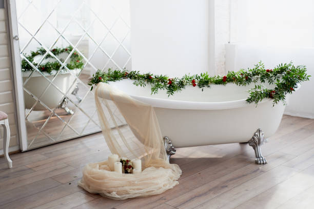 istock Bath on lion's paws, decorated with flowers. On the floor are candles.A romantic setting for a date 929151616