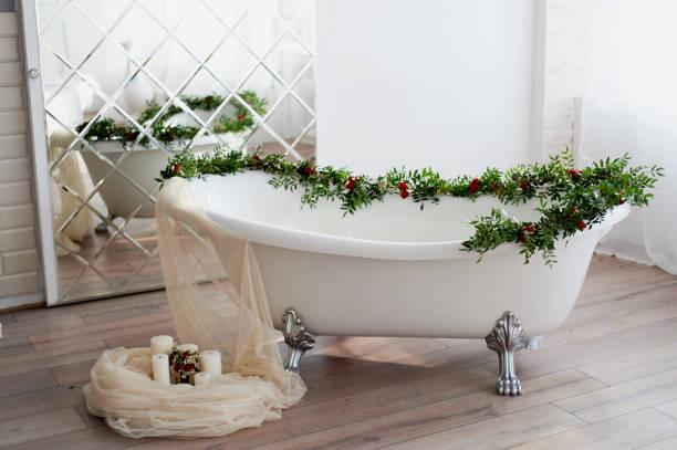 istock Bath on lion's paws, decorated with flowers. On the floor are candles.A romantic setting for a date 929151712