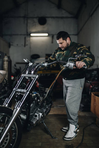 istock Man worker in motorcycle repair shop 929154288