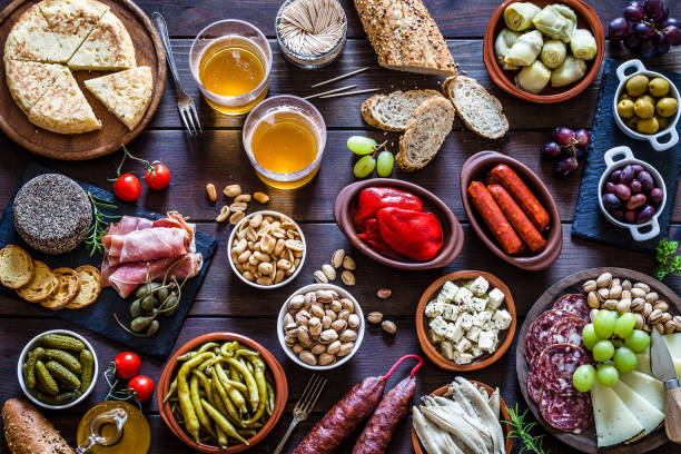 istock Tapas and beer on rustic wooden table shot from above 929178068