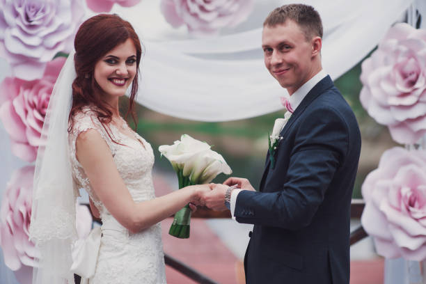 istock wedding couple holding hands, happy groom and bride 929178618