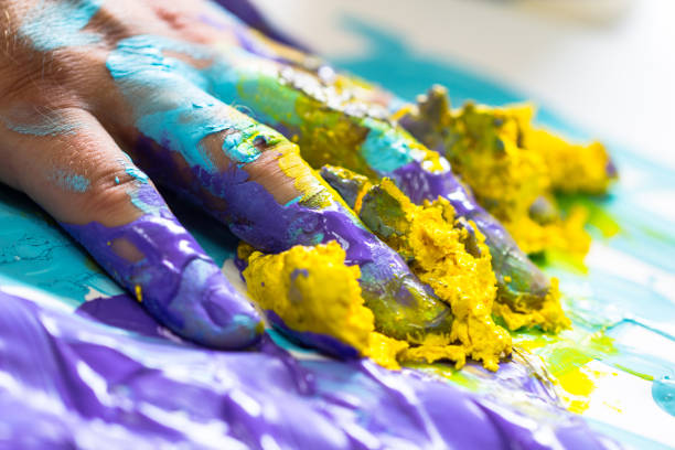 istock Fingers and hand dipped in colorful paint 929179704
