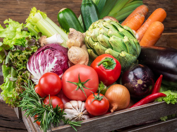 istock Fresh multi-colored vegetables in wooden crate. 929182400