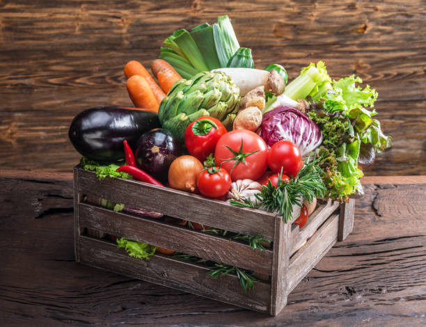istock Fresh multi-colored vegetables in wooden crate. 929182842
