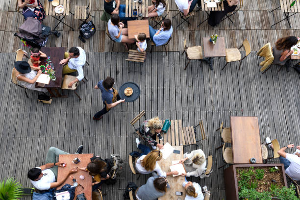 Paris, June 5, 2017 : people is havin lunch in a terrace restaurant, relaxing and friendly moment, style of life.