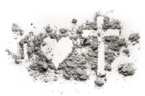 istock I, heart and cross or crucifix drawing in ash, sand or dust 929194296