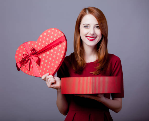 istock Young redhead girl with hearth shape box 929196790