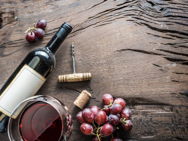 istock Wine glass, wine bottle and grapes on wooden background. 929200192