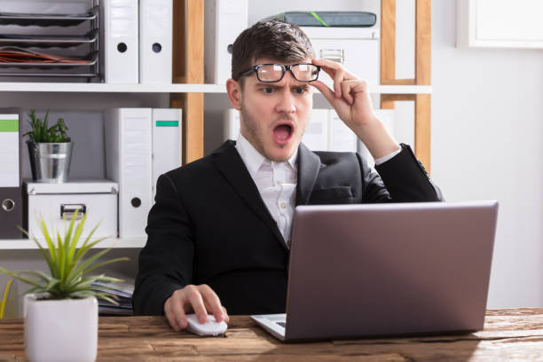 istock Shocked Businessman Looking At Laptop 929210780