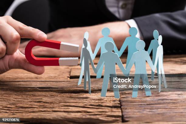 Businesspersons Hand Holding Horseshoe Magnet Attracting Leads Stock Photo - Download Image Now