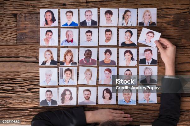 Businessperson Choosing Photograph Of Candidate Stock Photo - Download Image Now - Job Interview, Photograph, Choice