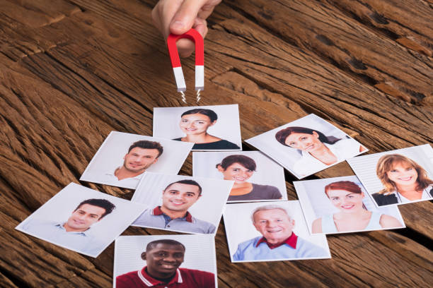 istock Businessperson's Hand With Horseshoe Magnet Attracting People 929210886