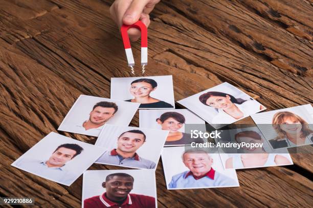 Businesspersons Hand With Horseshoe Magnet Attracting People Stock Photo - Download Image Now