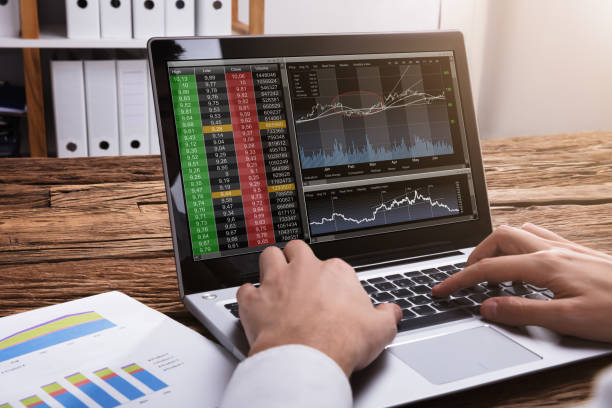 istock Stock Market Broker Looking At Graphs On Laptop 929211670