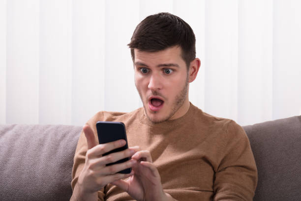 istock Shocked Man Looking At Smartphone 929212186
