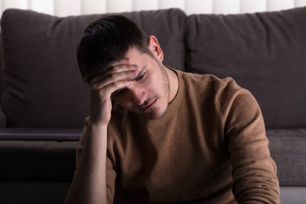 istock Sad Man Sitting In Front Of Sofa 929212210