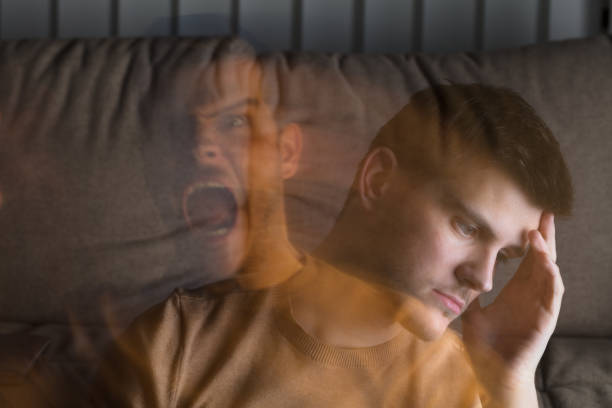 Angry And Stressed Man At Home Multi Exposure Of Young Angry And Stressed Man At Home bipolar disorder stock pictures, royalty-free photos & images