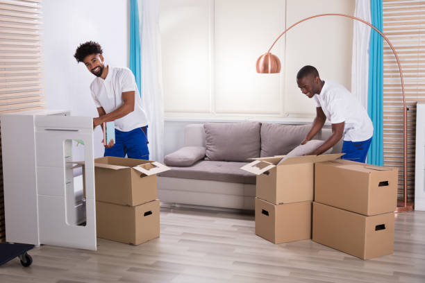 istock Movers Unpacking The Cardboard Boxes In The Home 929212788