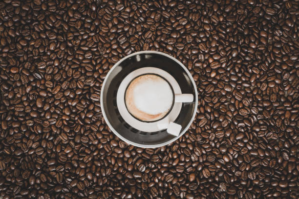 istock Single espresso coffee cup on coffee beans background 929215350