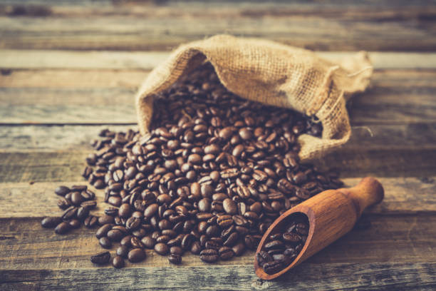 istock Roasted coffee beans in a bag on wooden background 929215630