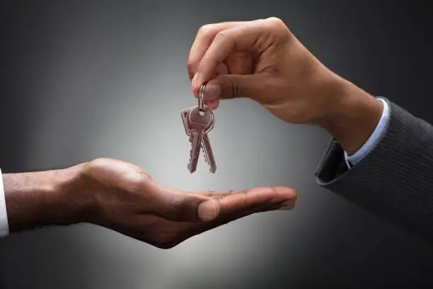 Photo of Hand Passing Keys To New Owner