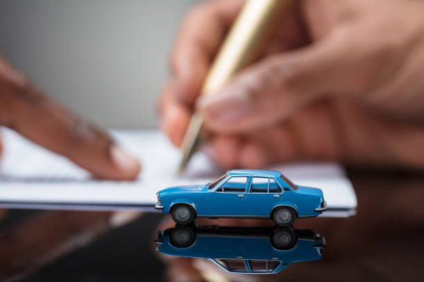 istock Person's Hand Signing Car Loan Agreement Contract 929215656
