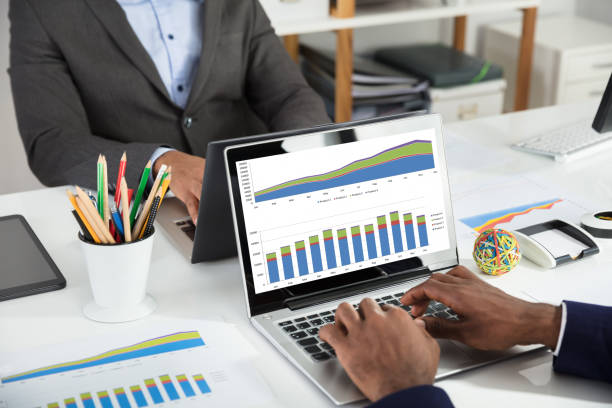 istock Two Businesspeople Analyzing Financial Graph On White Desk 929215782
