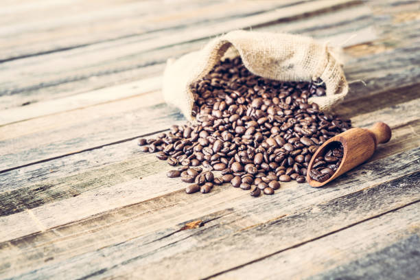 istock Roasted coffee beans in a bag on wooden background 929215796