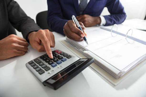 istock Two Accountants Calculating Tax Invoice Using Calculator 929216078
