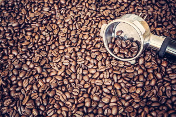 istock Espresso machine scoop on coffee beans background 929216850