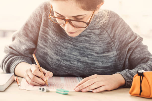 Young female student in examination stock photo
