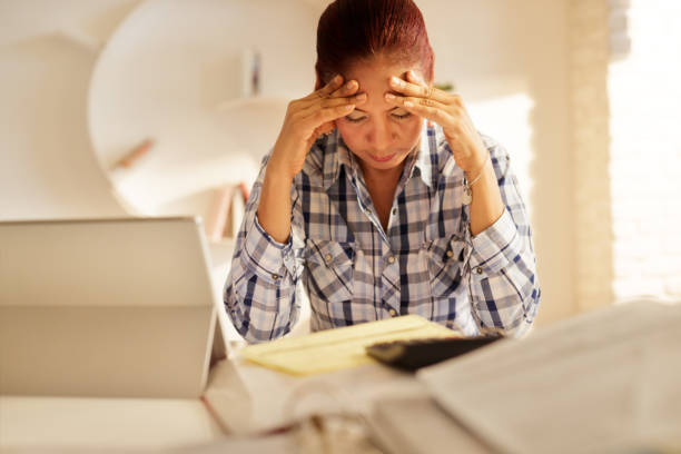 Angry Senior Woman Paying Bills And Filing Federal Tax Return stock photo