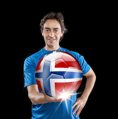 Soccer player Norway holding ball with norwegian flag isolated on black