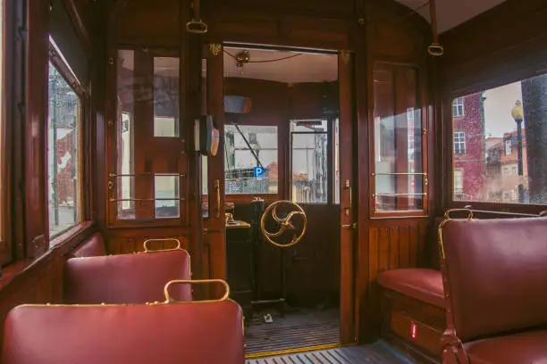 Photo of In the car of an old tram. Seats for passengers and control cabin