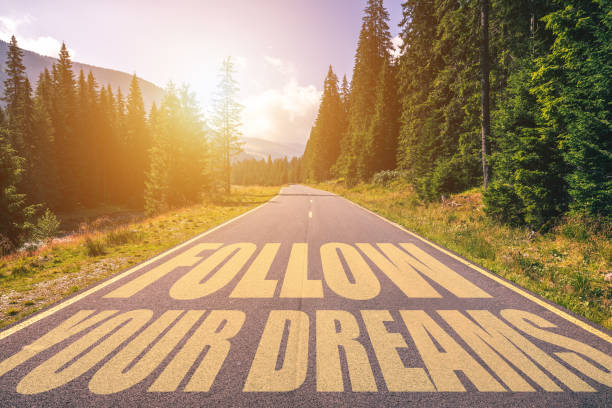 istock Follow your dreams text written on road in the mountains 929231106