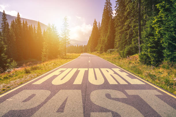 istock Empty asphalt road and Past and Future concept. Driving on an empty road in the mountains to the Future and leaving behind the Past. Concept for success and passing time. 929231152