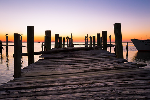 Photo of a dock that was damaged from Hurricane Matthew at sunset
