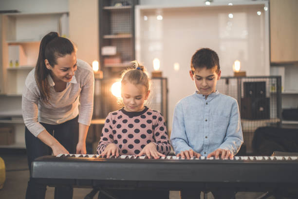 istock Boy and girl playing piano 929248848