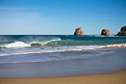 beautiful beach in hendaye with breaking waves in sunny weather blue sky, basque country, france