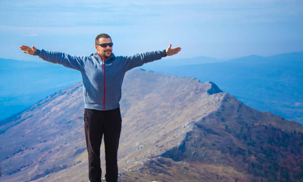 istock Young man on top of high mountain. 929249556