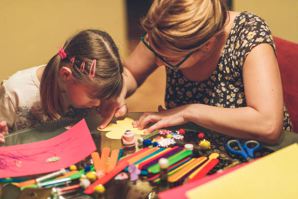 istock Mother crafting at home with daughter 929254170