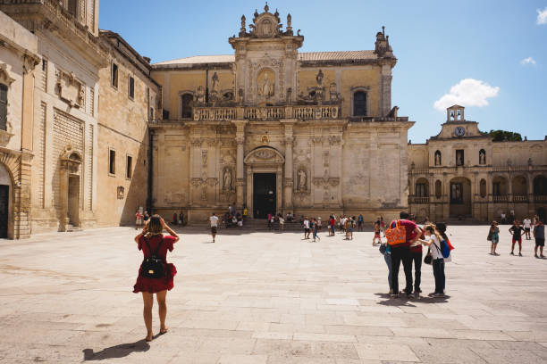 view of the baroque cathedral of lecce dedicated to the assumption of the virgin mary with its bell tower. - baroque style lecce italy puglia imagens e fotografias de stock