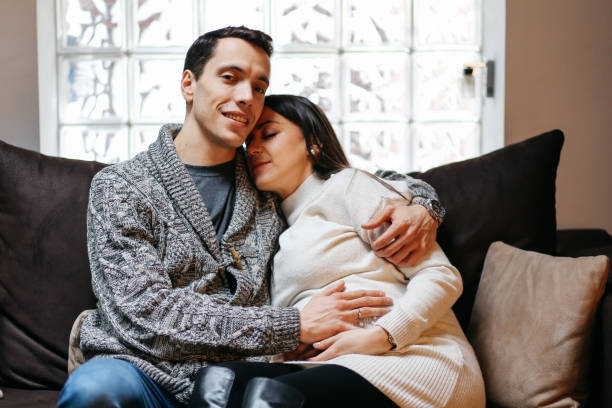 istock Smiling young couple expecting a baby, relaxing at home 929260740