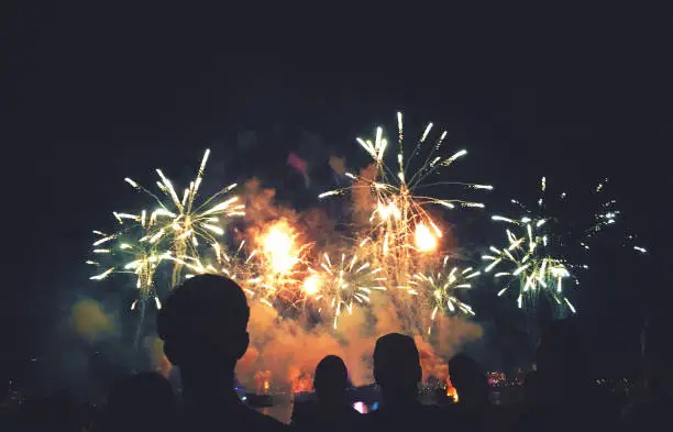 Photo of Silhouetted People Watching a Fireworks Display