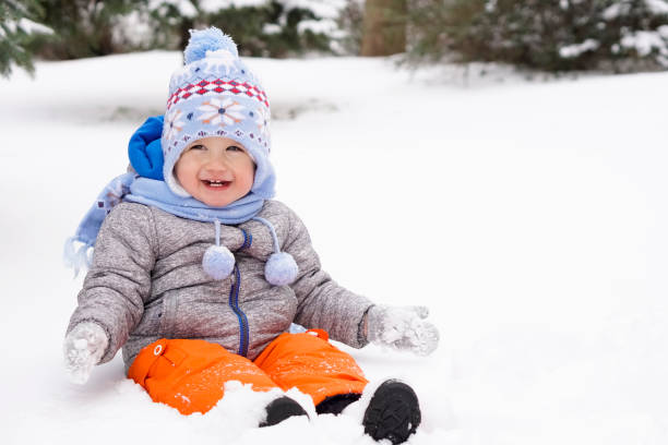 istock Toddler sitting in the snow and having fun 929265982