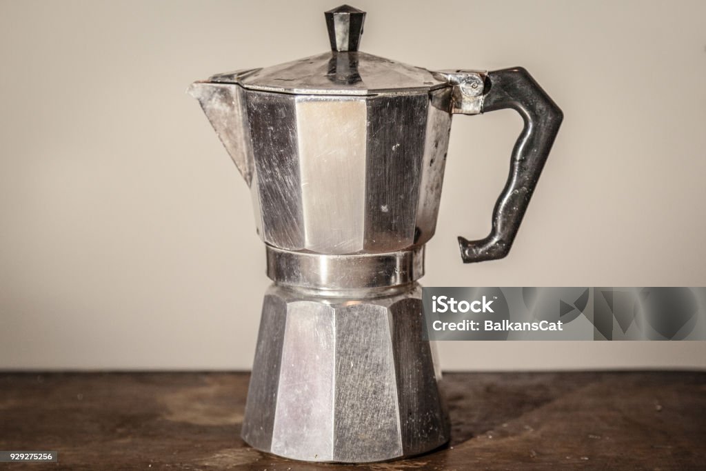 Isolated Vintage Moka Pot On A White Background Standing On A Retro Wooden  Table Mocha Pots Are The Most Used Espresso Coffee Machines In Italy Stock  Photo - Download Image Now - iStock