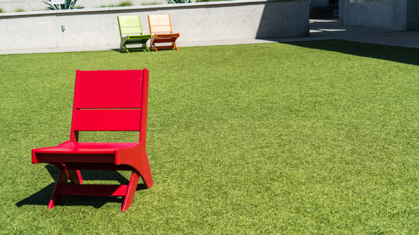 istock Red chair in grass field 929297172